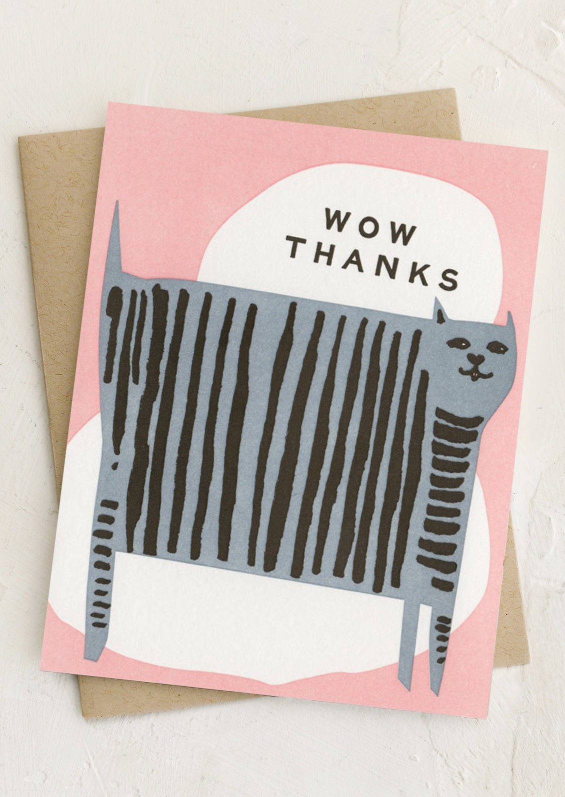 A pink greeting card with illustration of striped grey cat, text reads "Wow thanks".