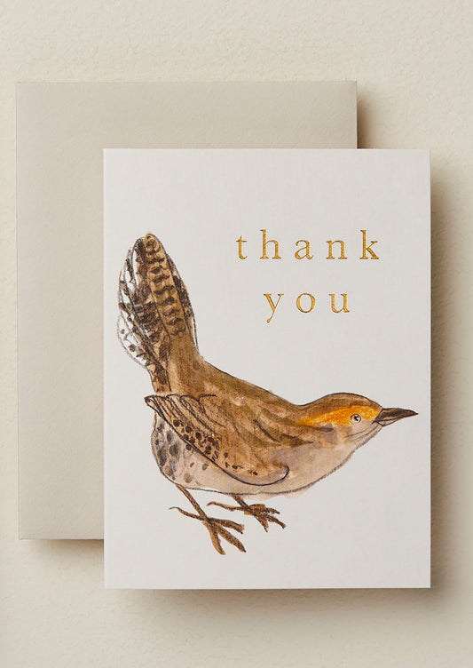 A small card with illustration of bird, gold lettering reads "Thank you".