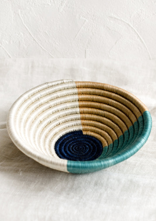 A round sweetgrass bowl in navy pattern.