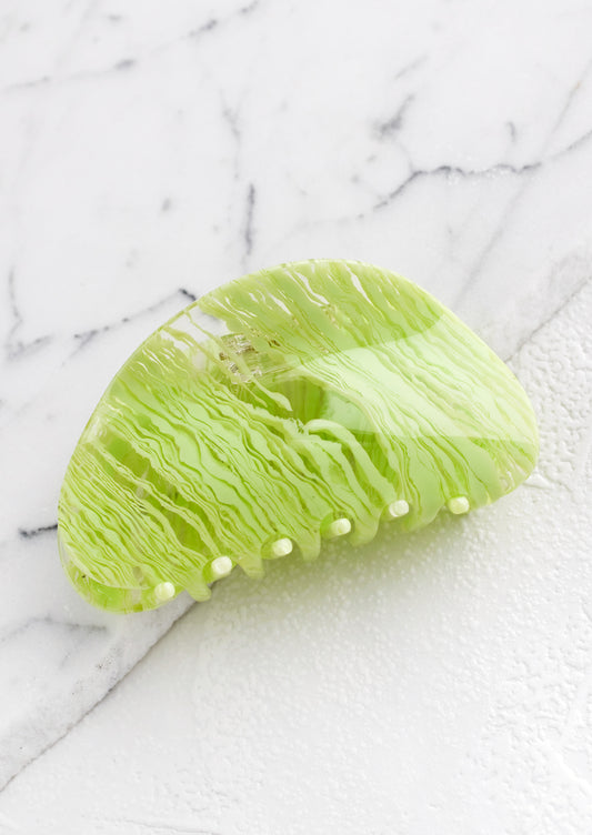 An asymmetric hair claw in lime streak print.