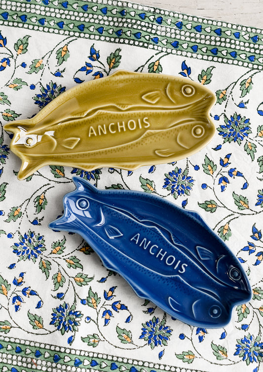 Green and blue ceramic dishes in shape of sardines.