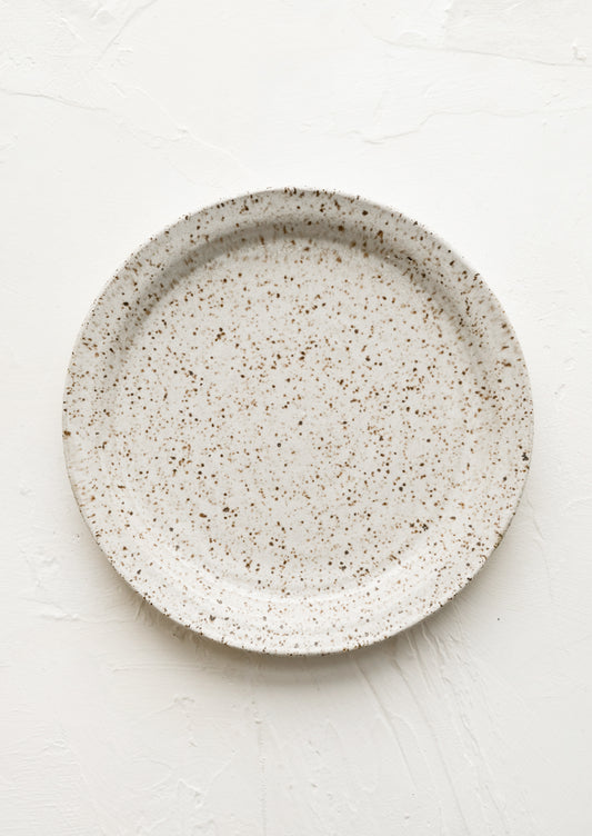 A ceramic side plate in natural speckle glaze.