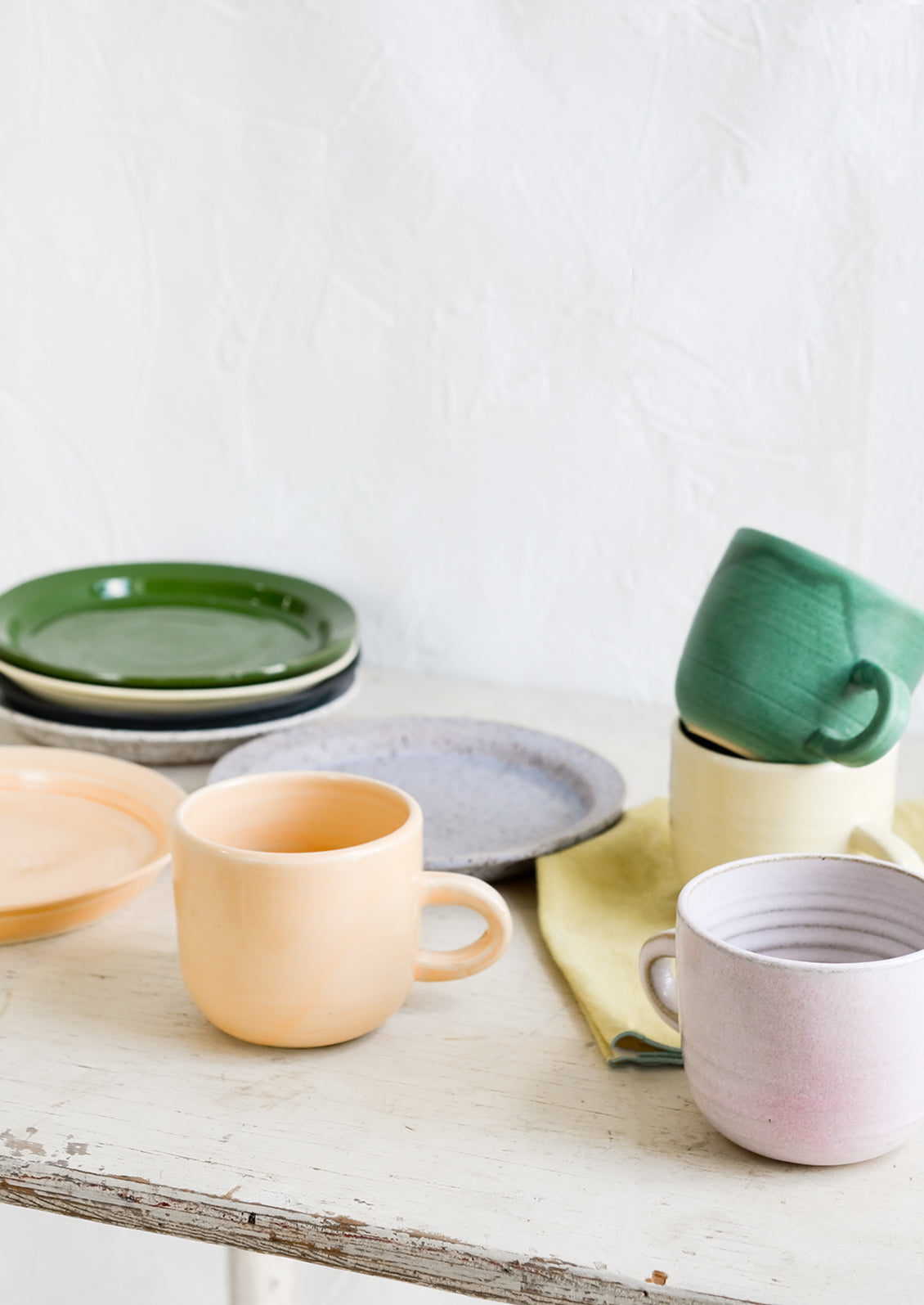 A mix of hand glazed plates and mugs.