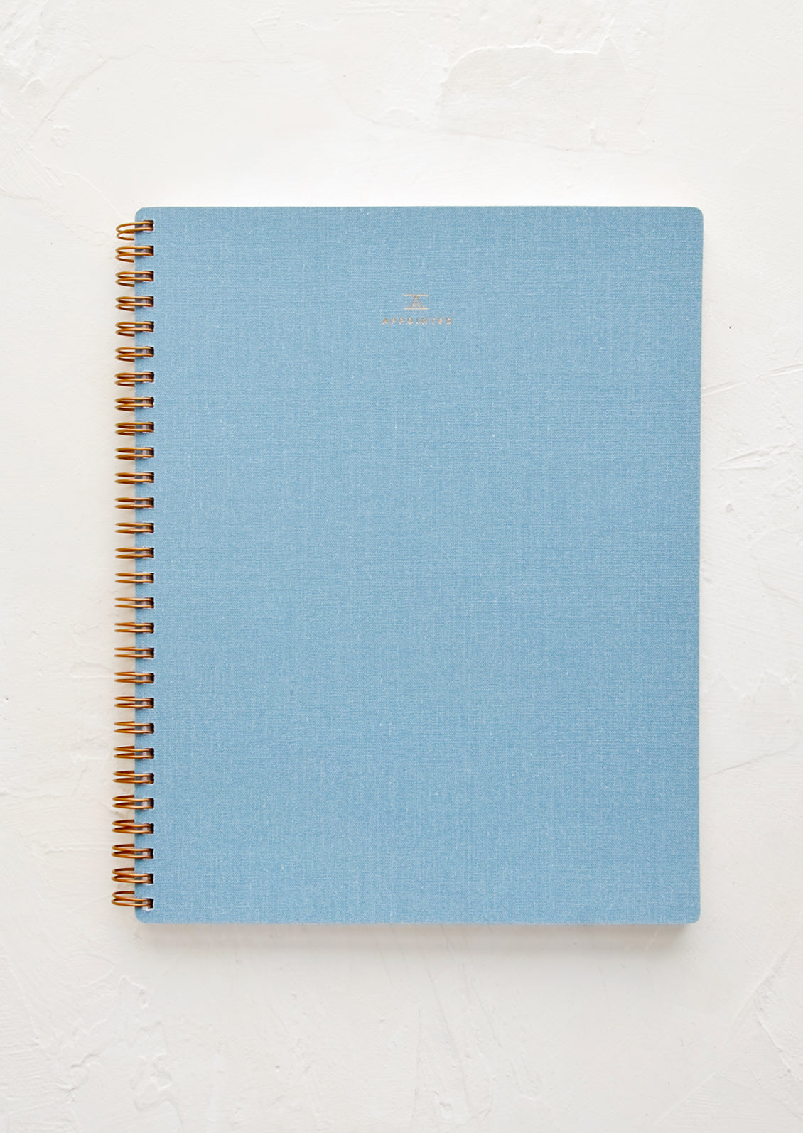 A spiral bound notebook in blue.