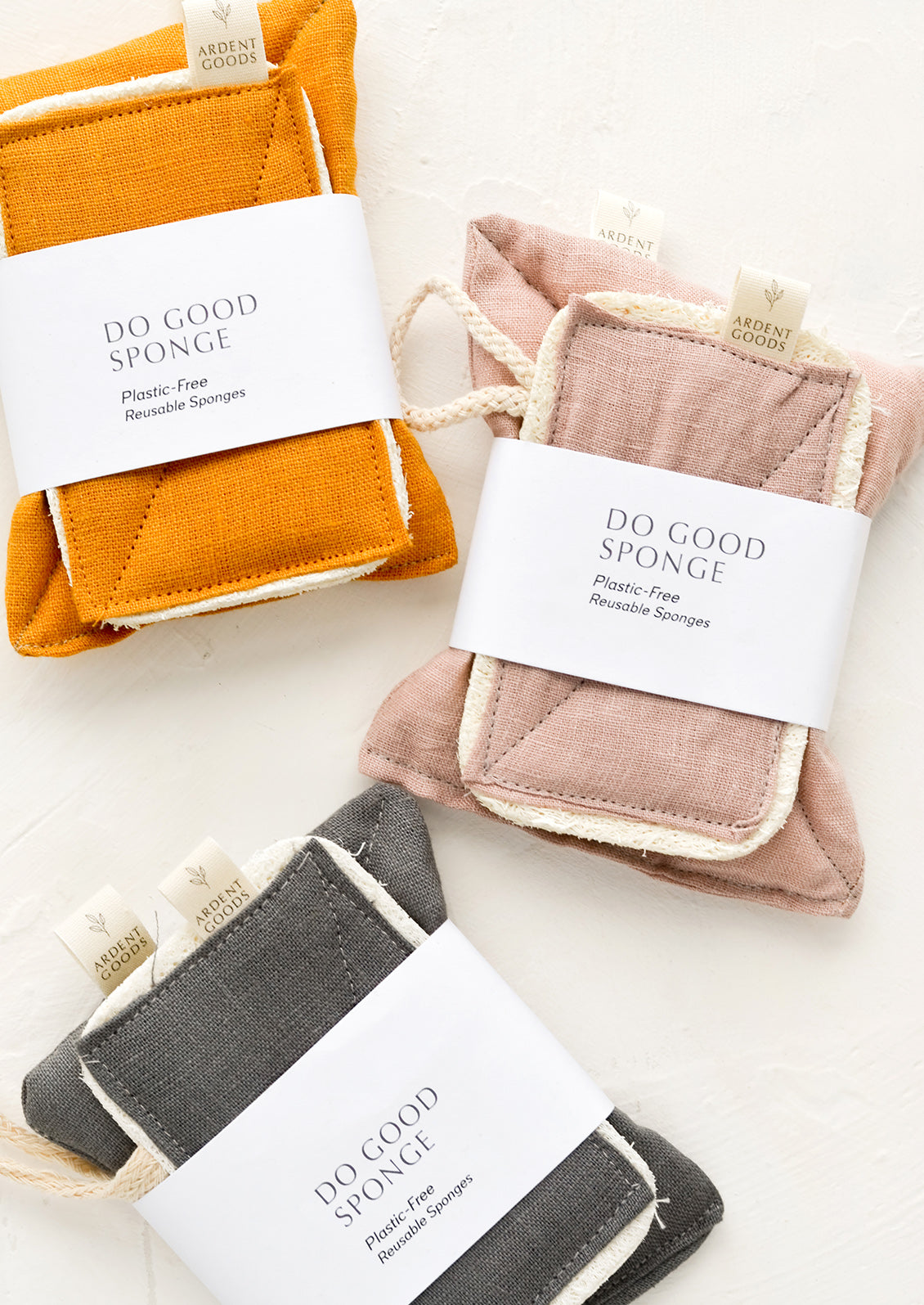 Three linen sponge sets in amber, rose and charcoal.