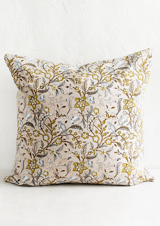 A block printed throw pillow with aviary print.
