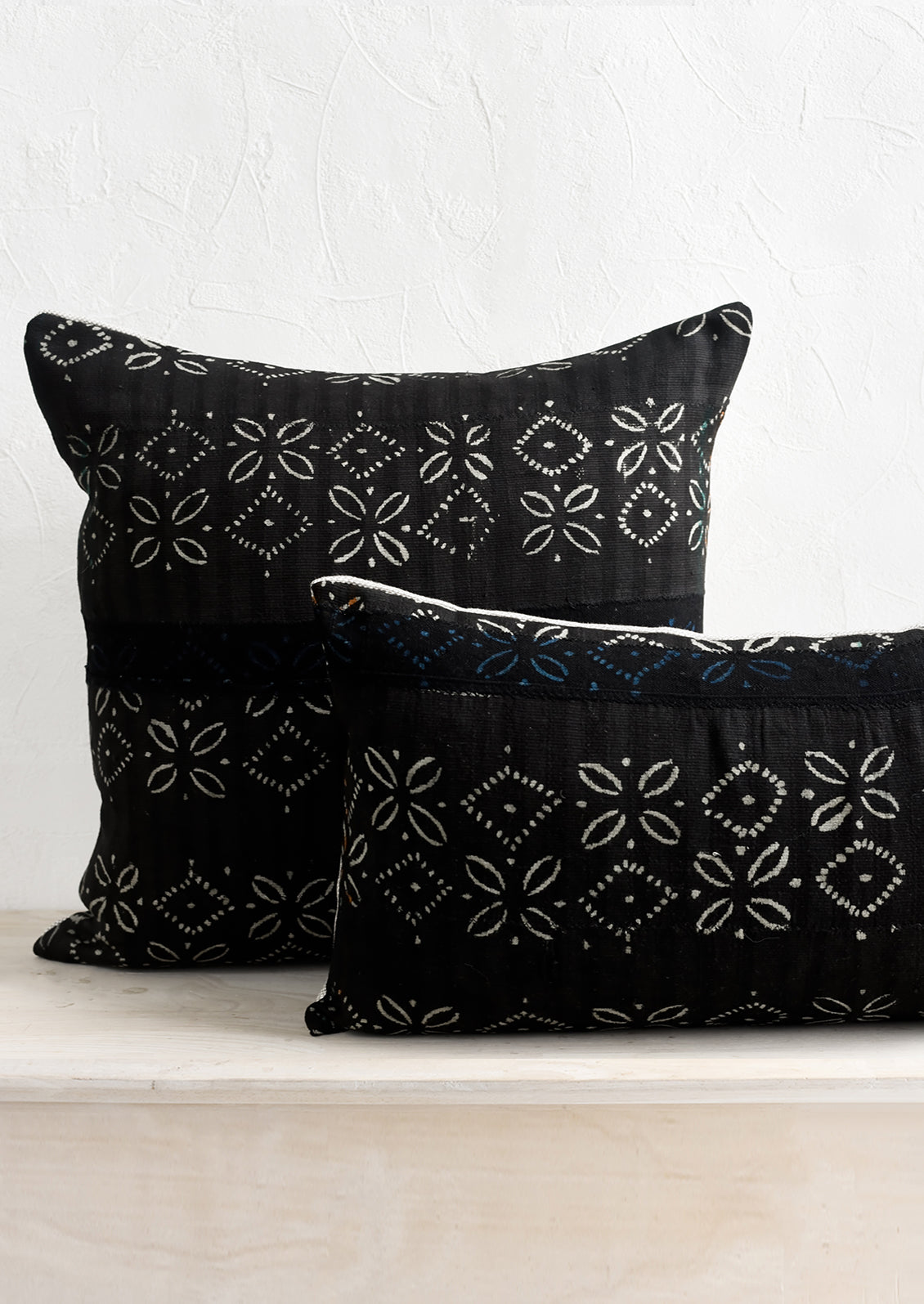 Black vintage fabric pillows in square and lumbar sizes.