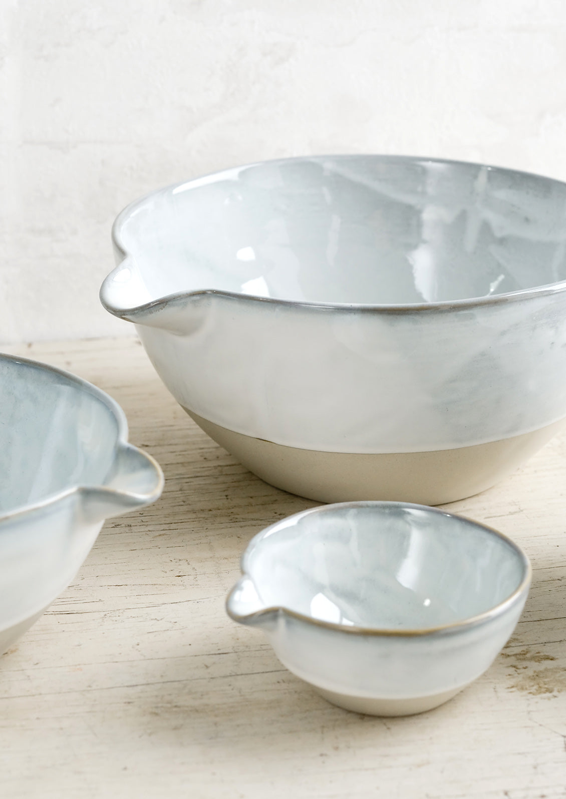 Ceramic bowls with pouring spouts in three sizes.