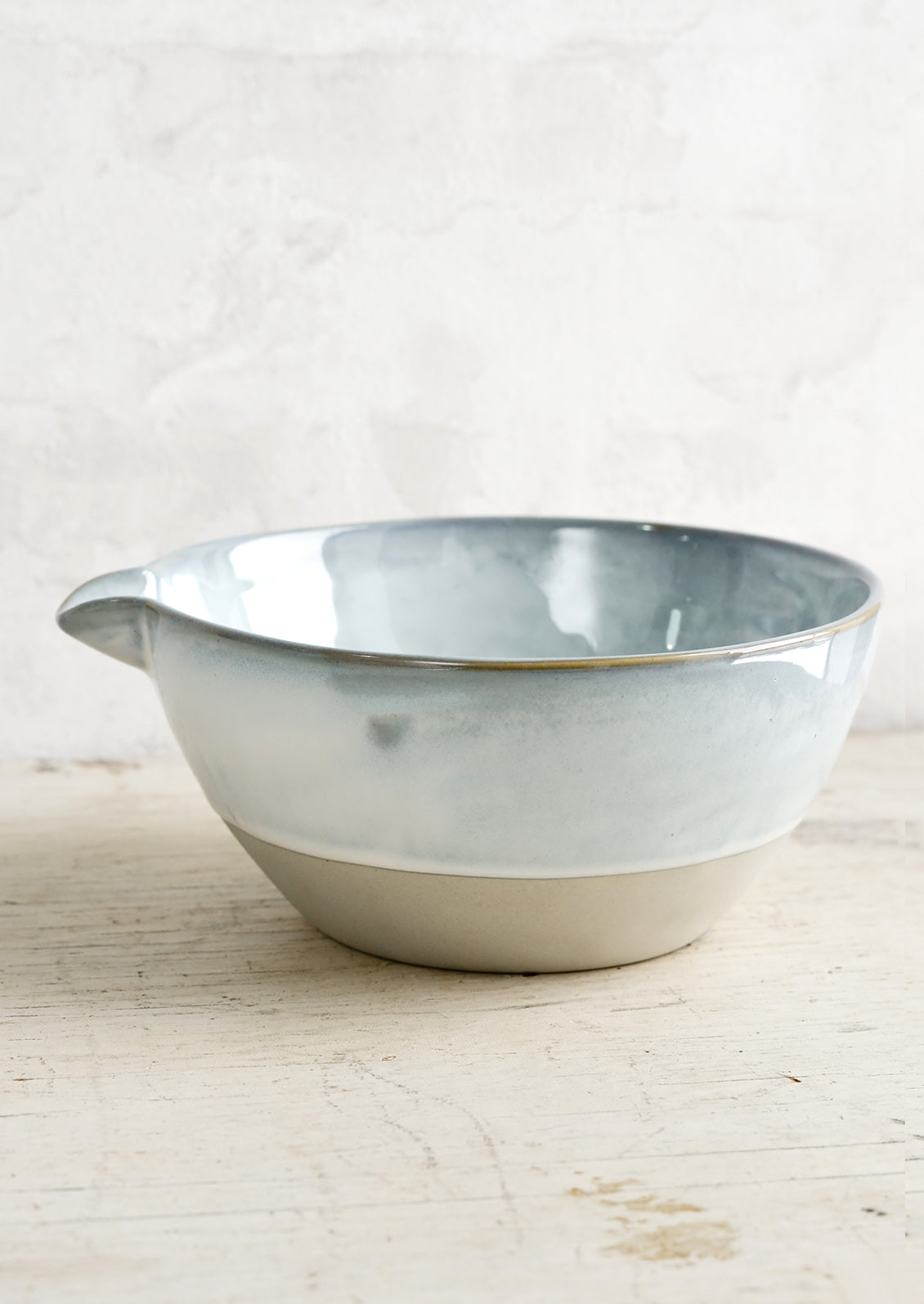 A ceramic bowl with pouring spout.