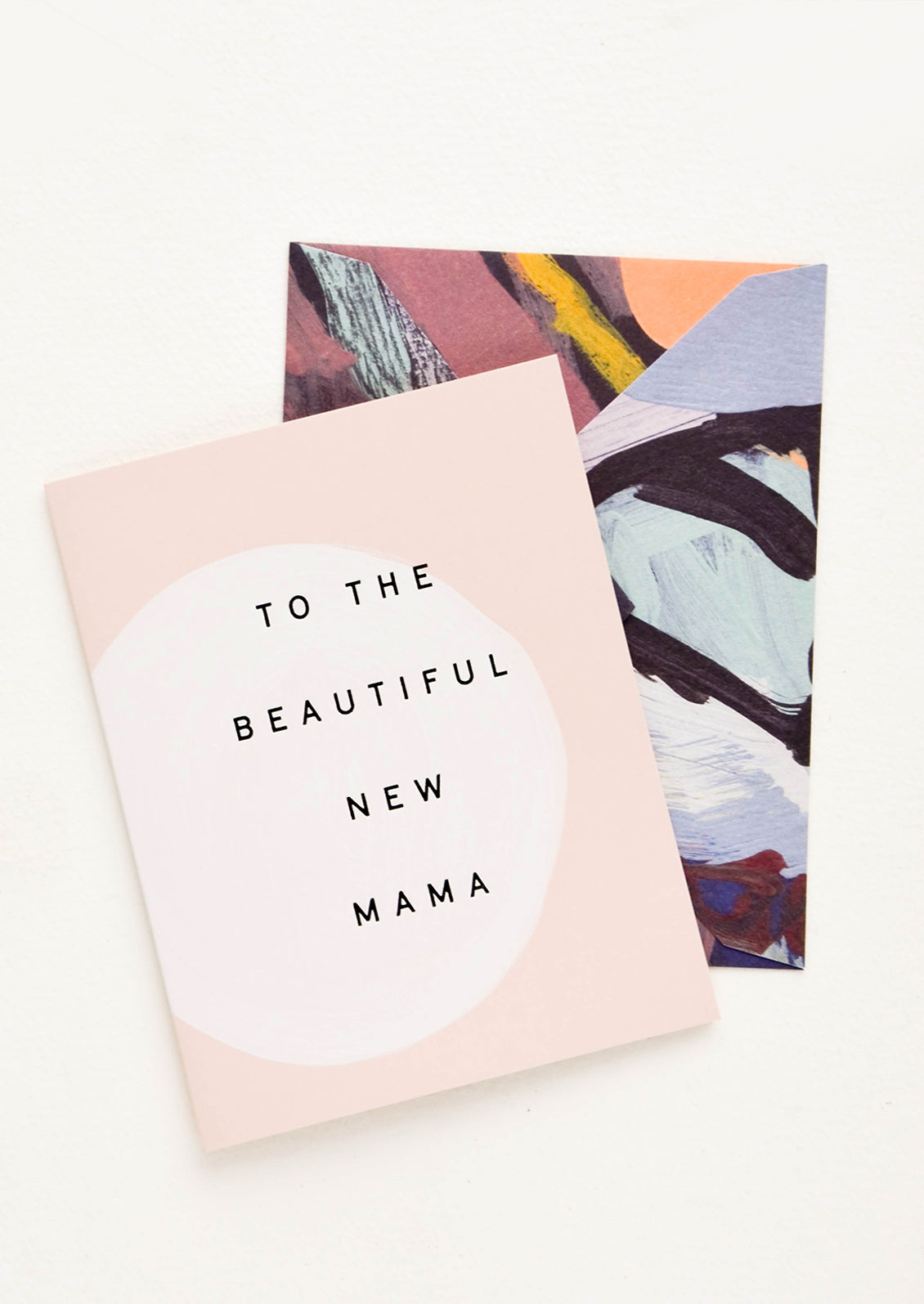 Greeting card with hand painted circle and black text reading "To The Beautiful New Mama", paired with abstract printed envelope