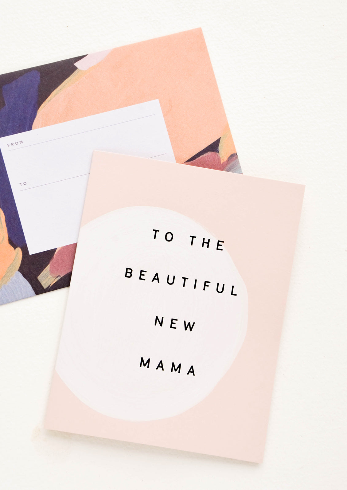 Greeting card with hand painted circle and black text reading "To The Beautiful New Mama", paired with abstract printed envelope