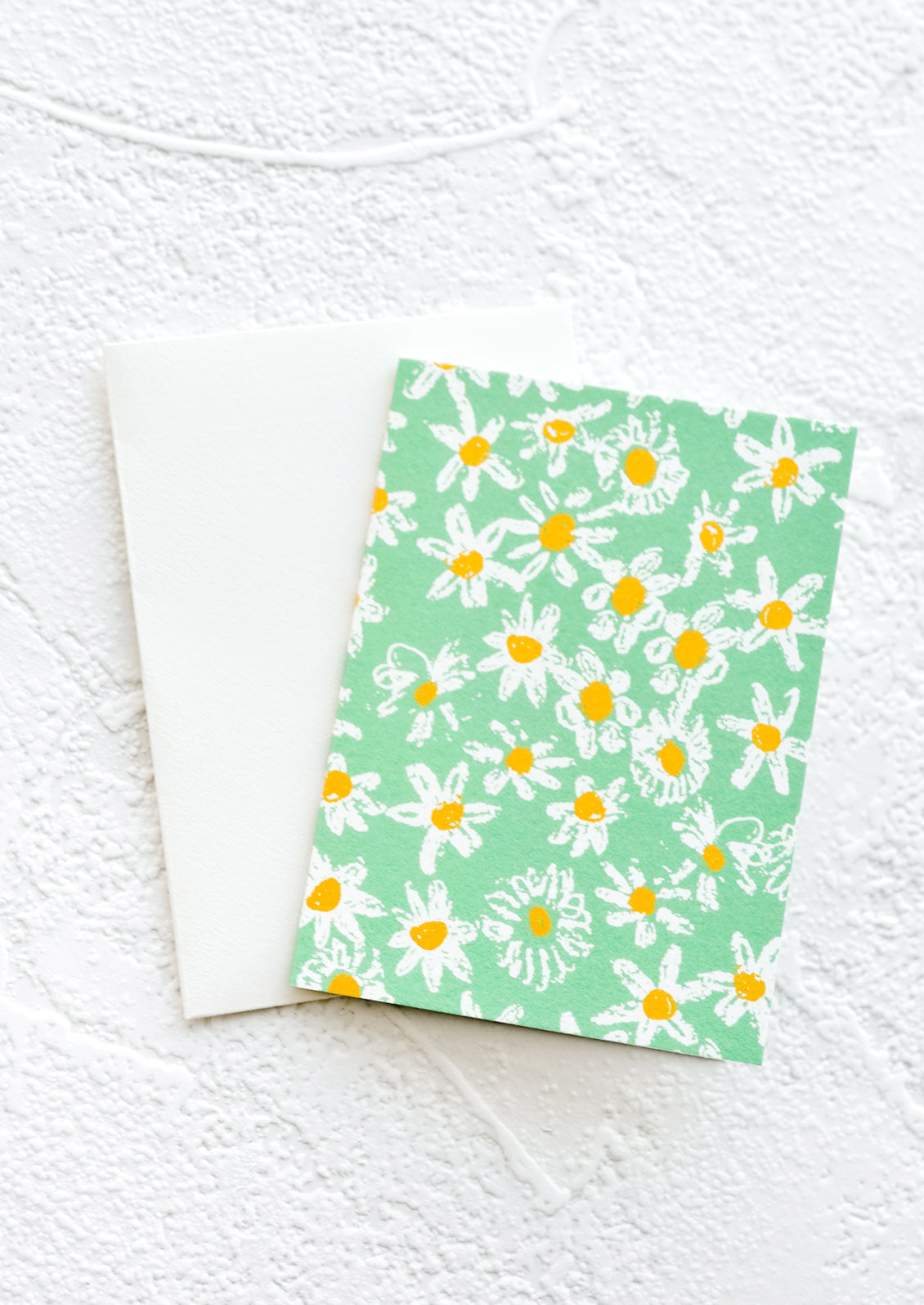 A gift enclosure greeting card with a green background and daisy print.