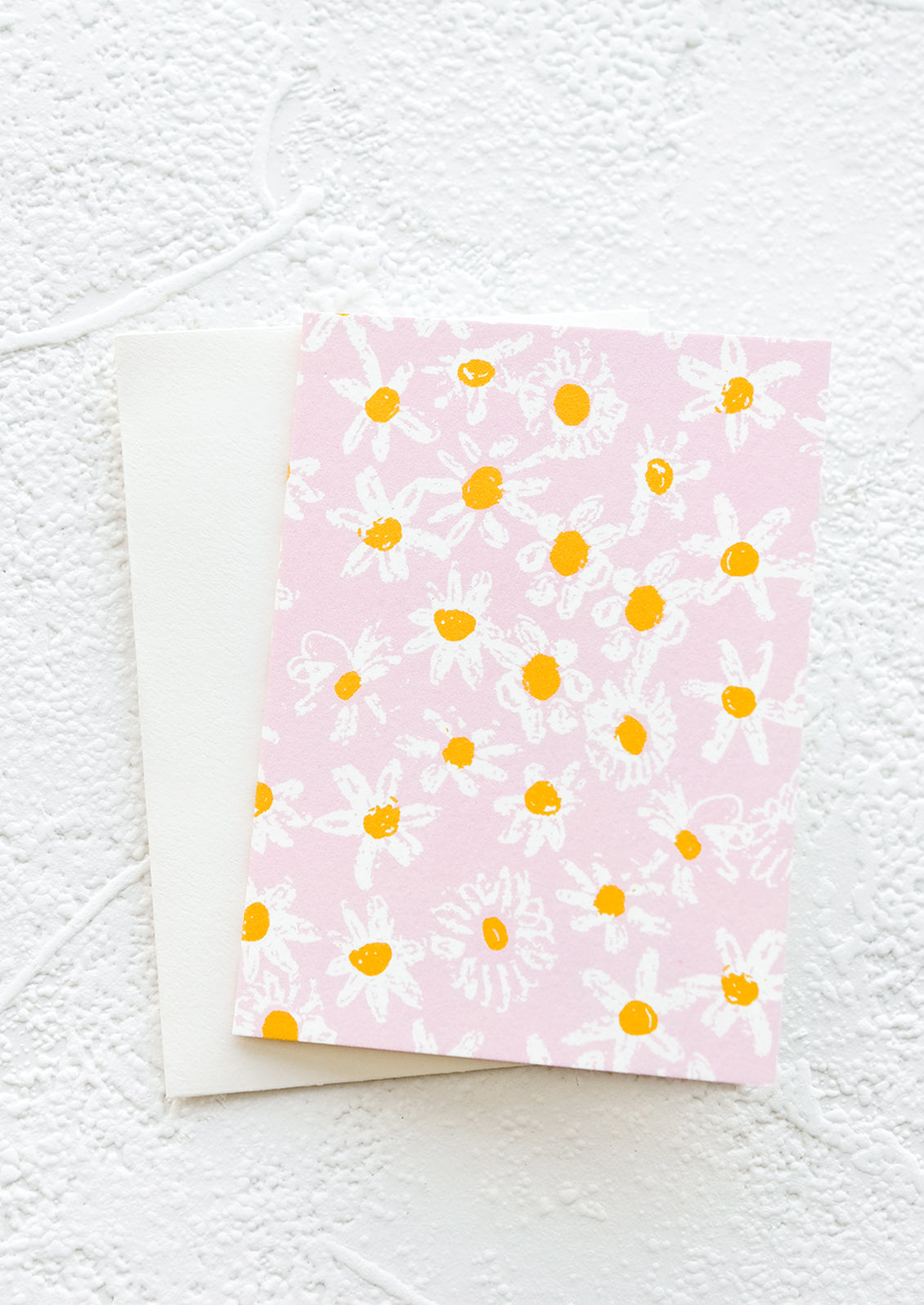 A gift enclosure greeting card with a pink background and daisy print.