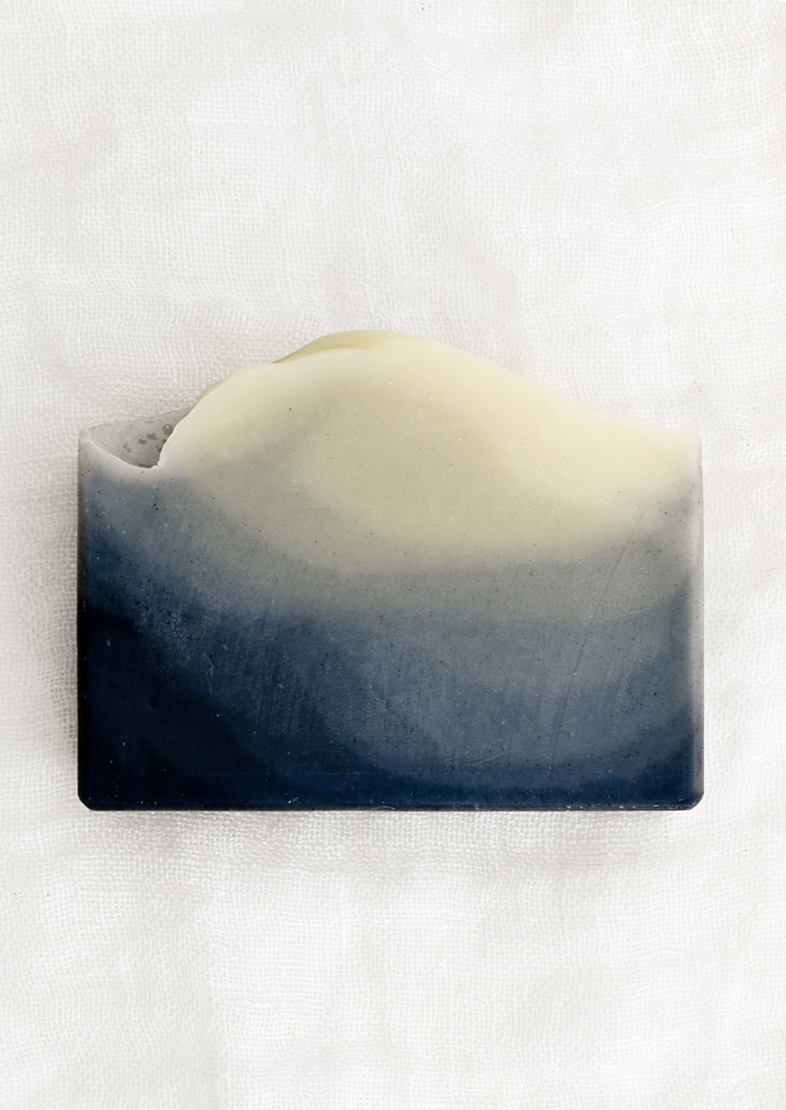 A bar of soap in indigo style (layered charcoal pattern).