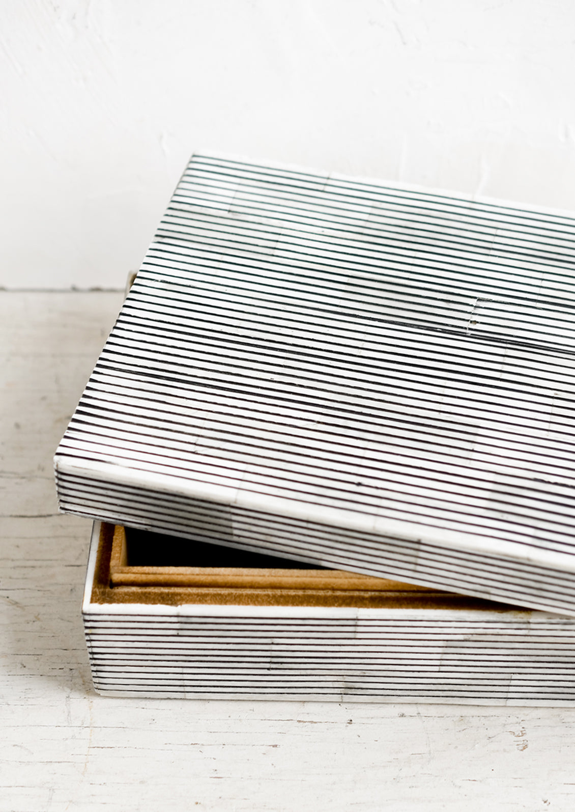 A large lidded storage box made from black & white striped bone.