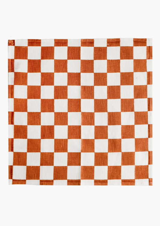 A checkered linen napkin in terracotta and white.