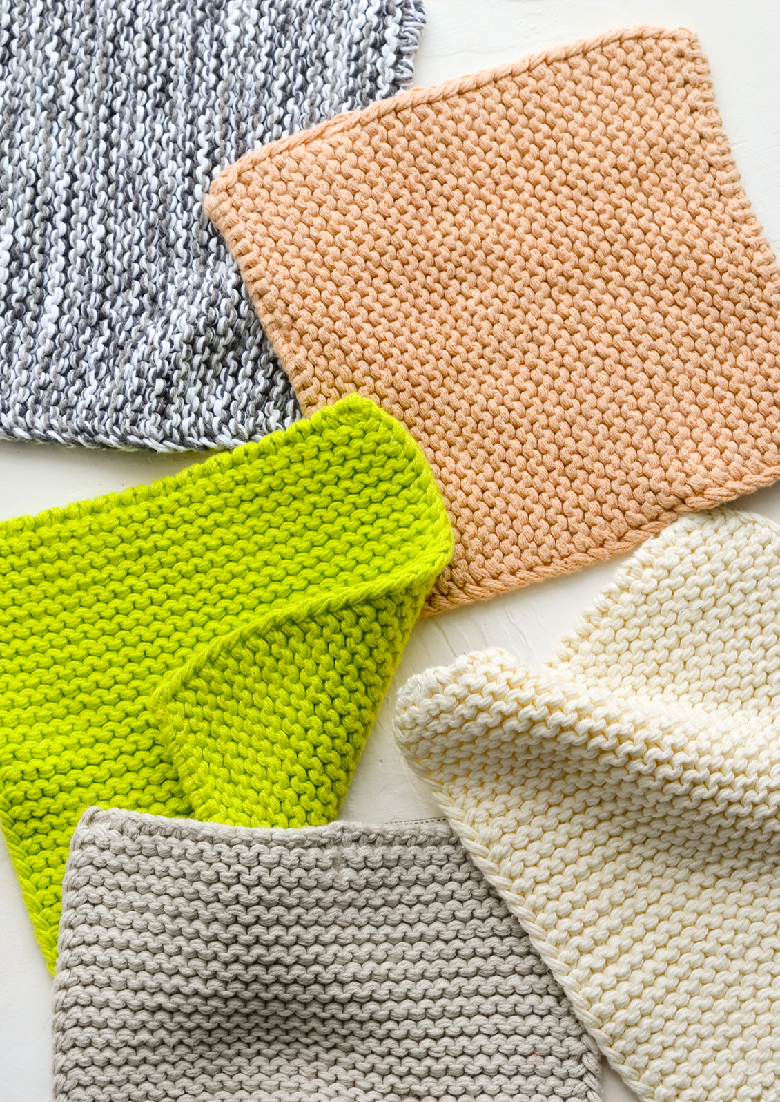 Chunky knit potholder squares in assorted colors.