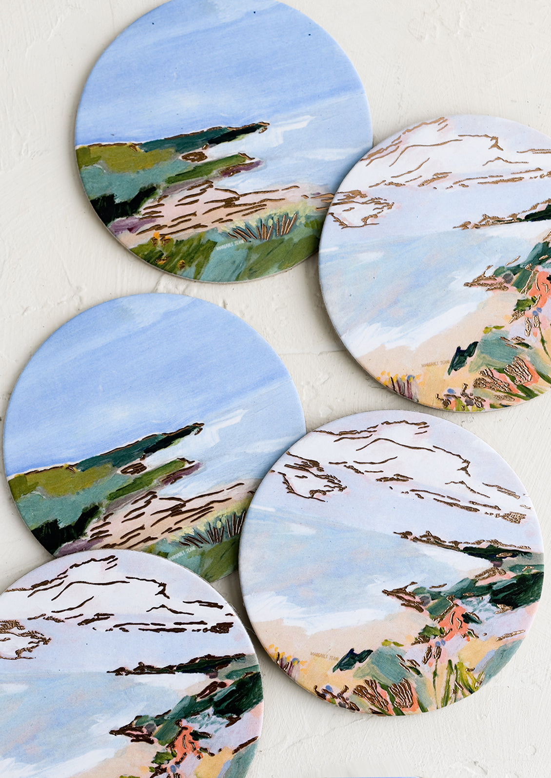 A set of six printed round coasters in coastal print.