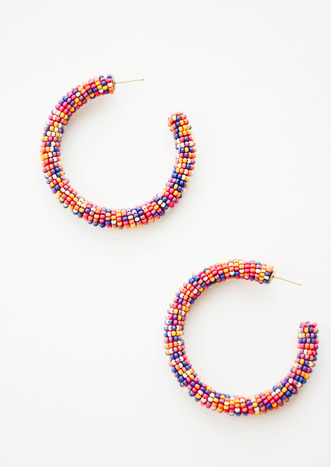 Mixed multicolored beaded hoop earrings. 