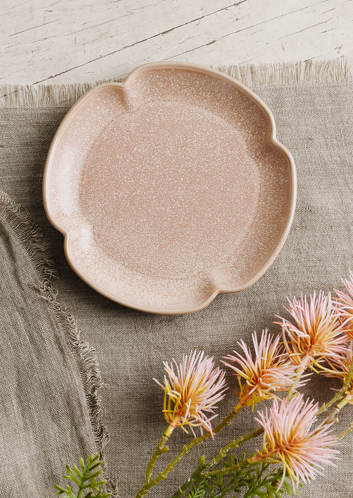 A quartrefoil shaped ceramic plate in rose pink.