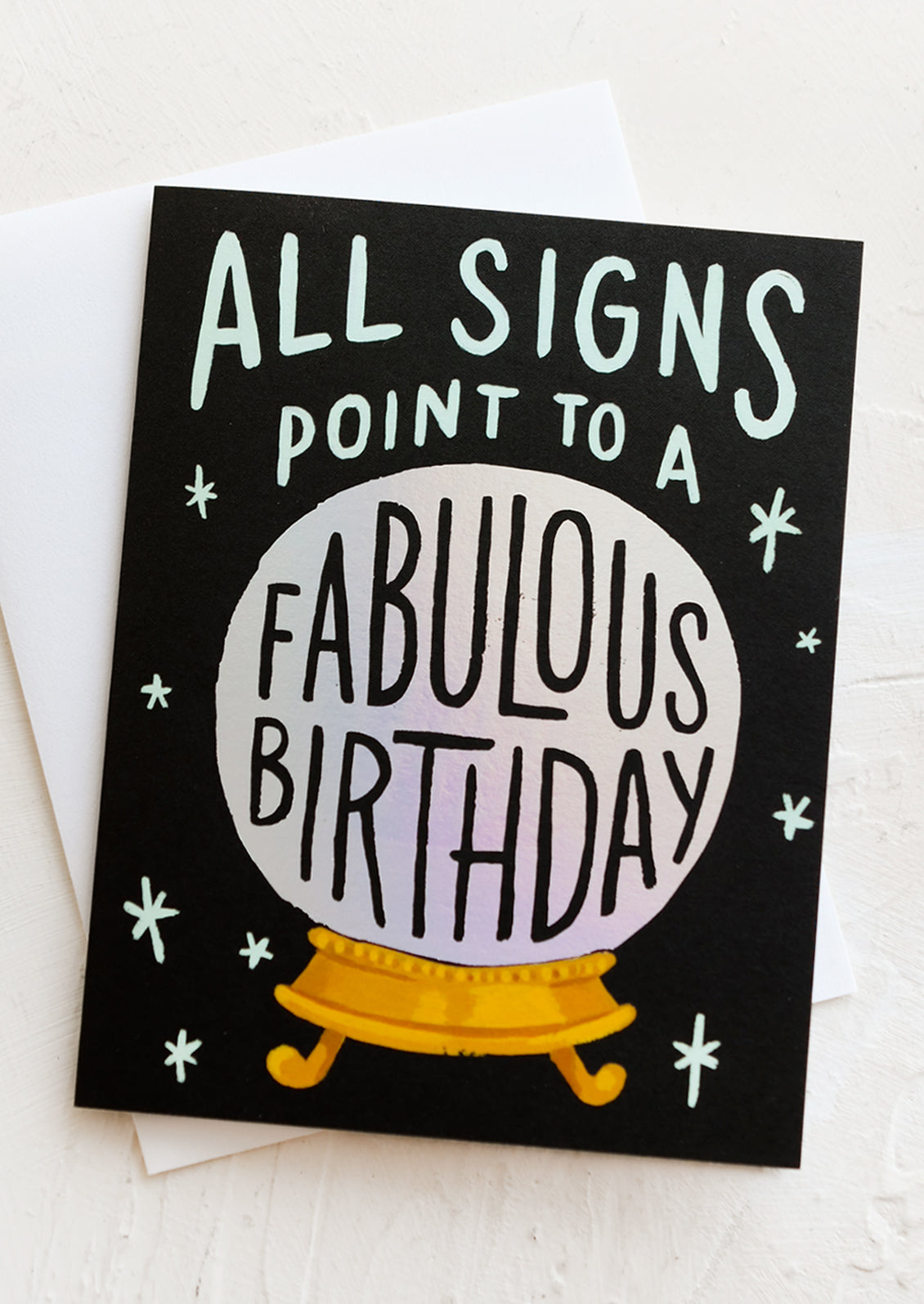 A birthday greeting card with image of crystal ball and text reading "All signs point to a fabulous birthday".