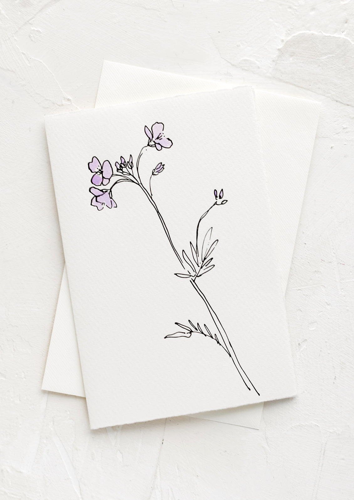 A white greeting card with a hand painted illustration of a cuckoo flower.