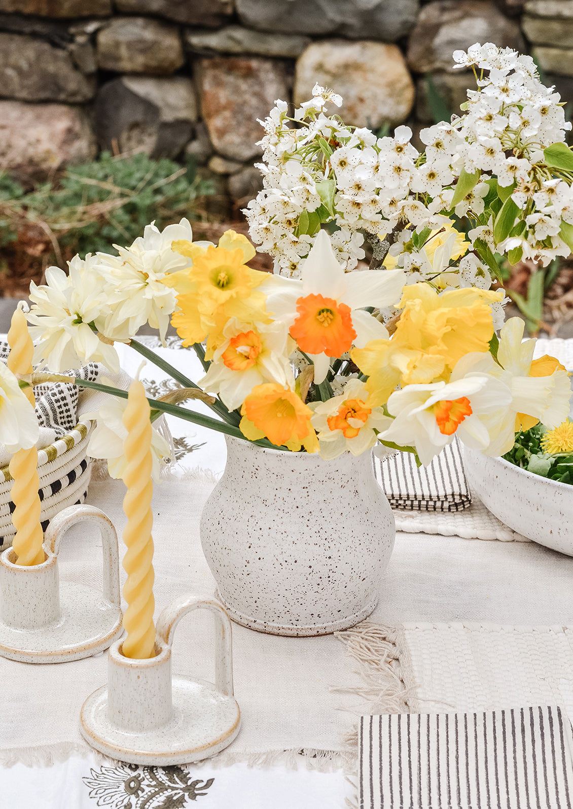 Ceramics and flowers on a table setting.