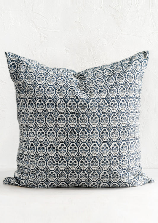 A block printed pillow in blue and white tile print.