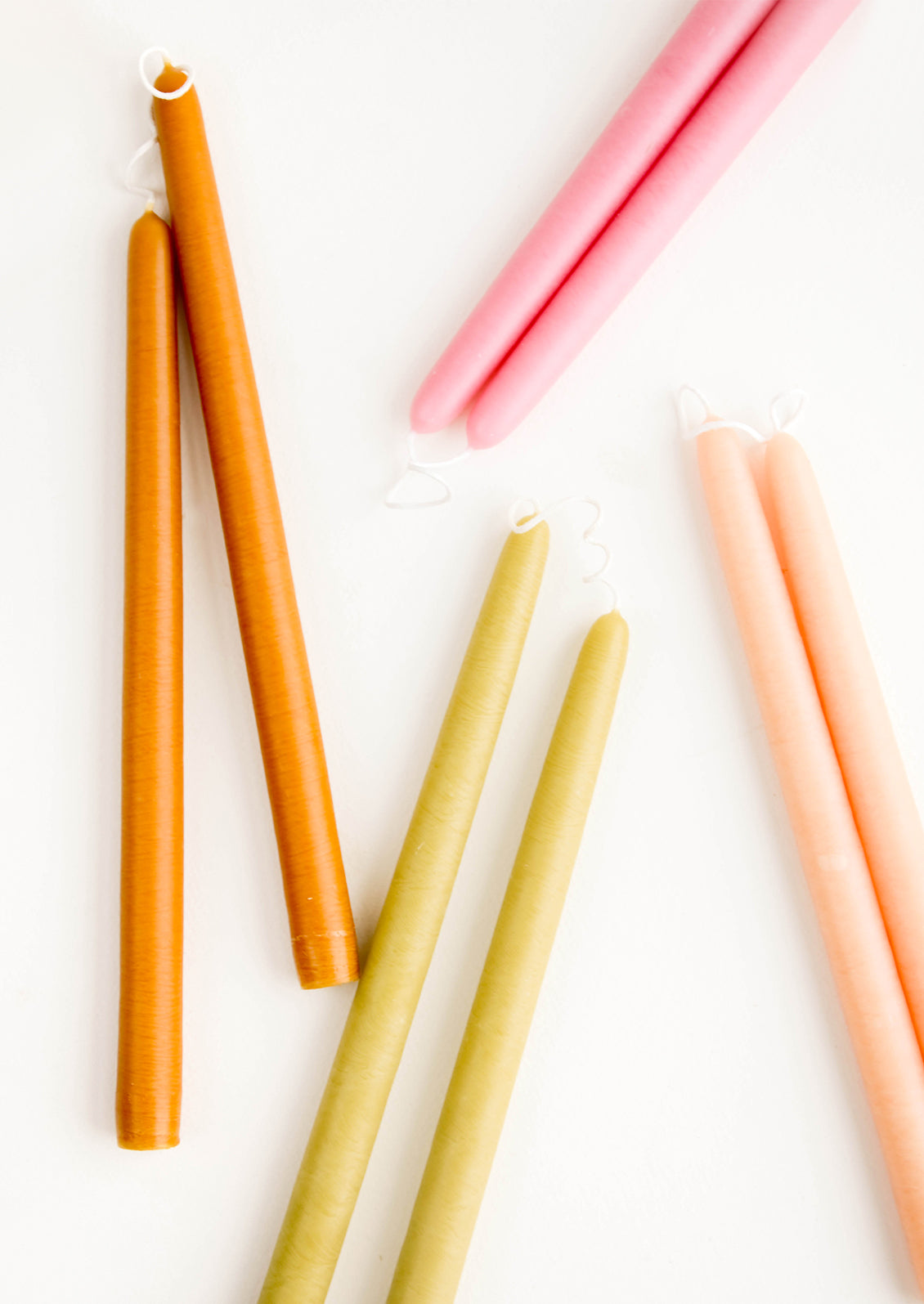 An arrangement of colorful taper candles