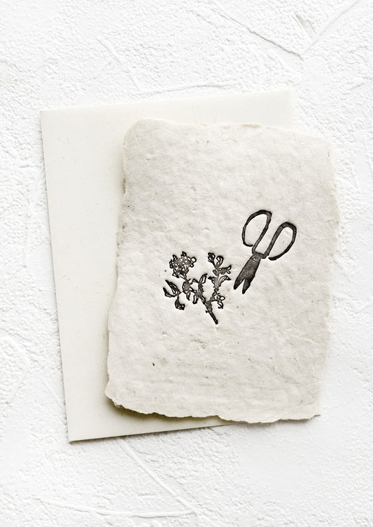 A greeting card made from handmade paper with a letterpress printed image of garden shears.