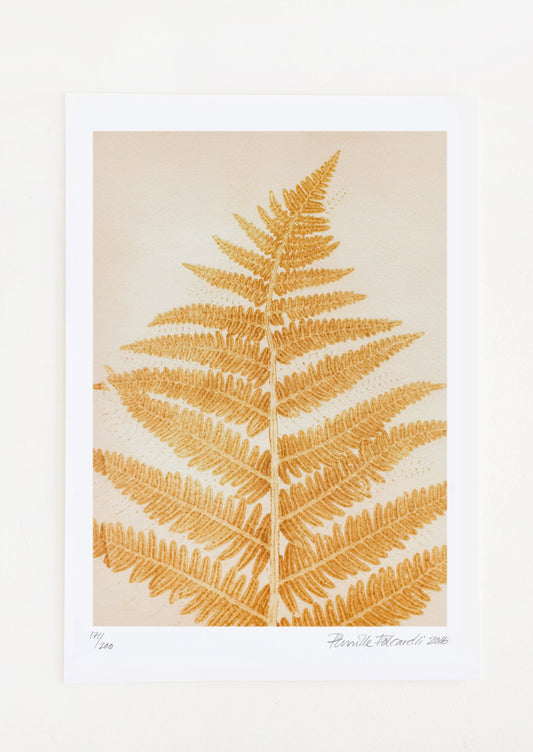 A botanical print of a fern frond in yellow mustard color.