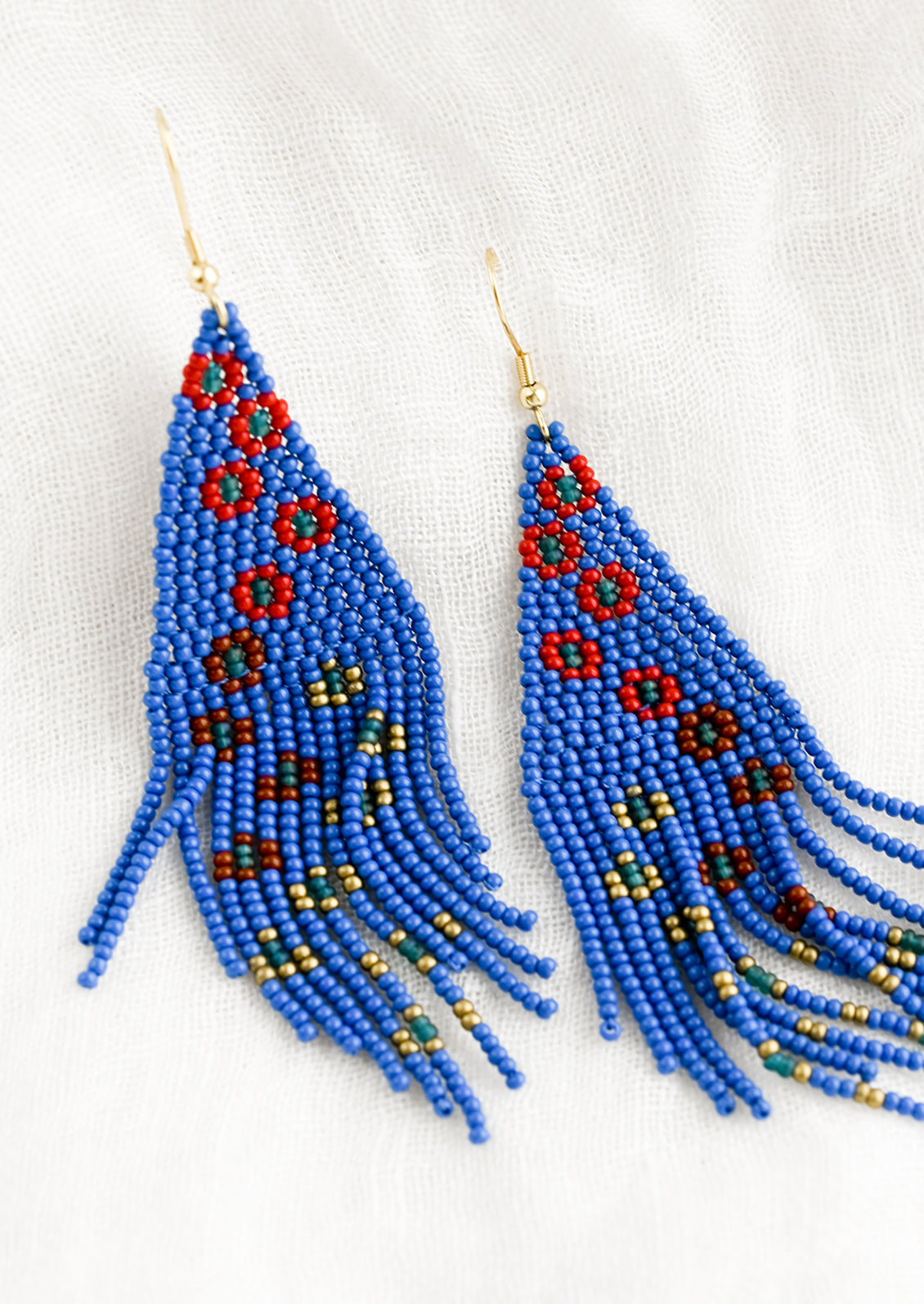 A pair of beaded floral earrings in cobalt blue.