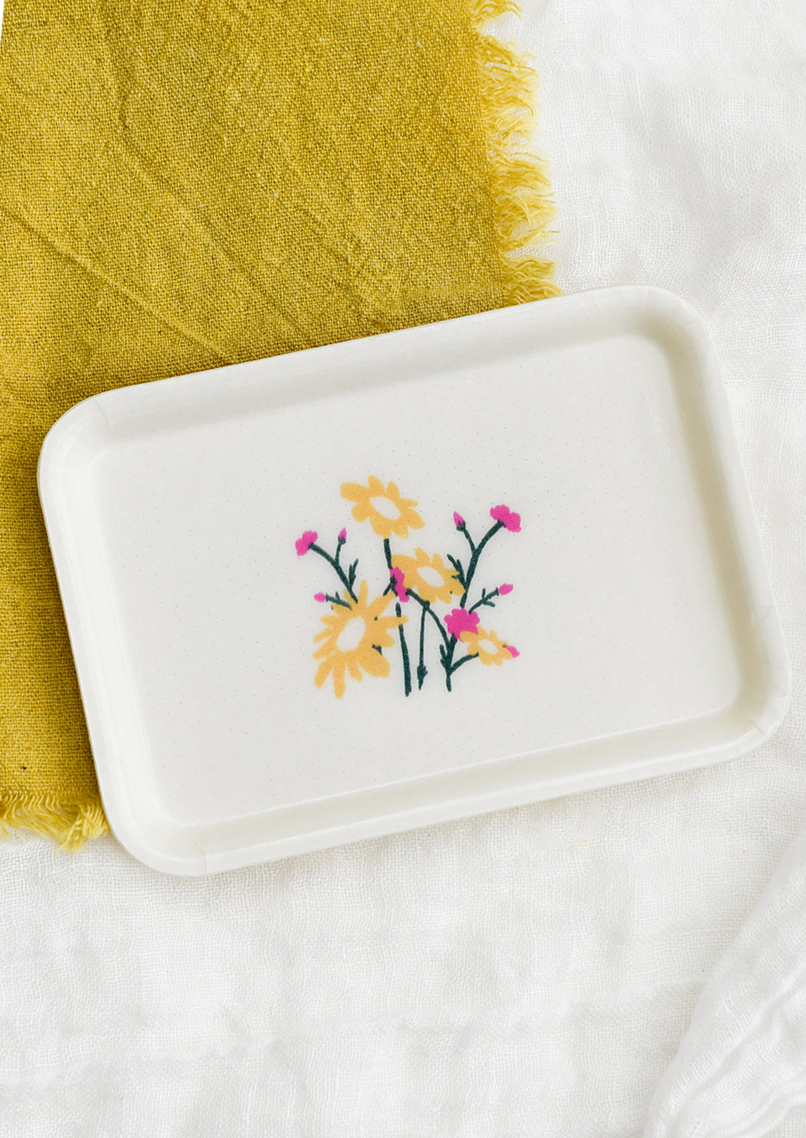 A rectangular fiberglass tray in ivory with floral motif.