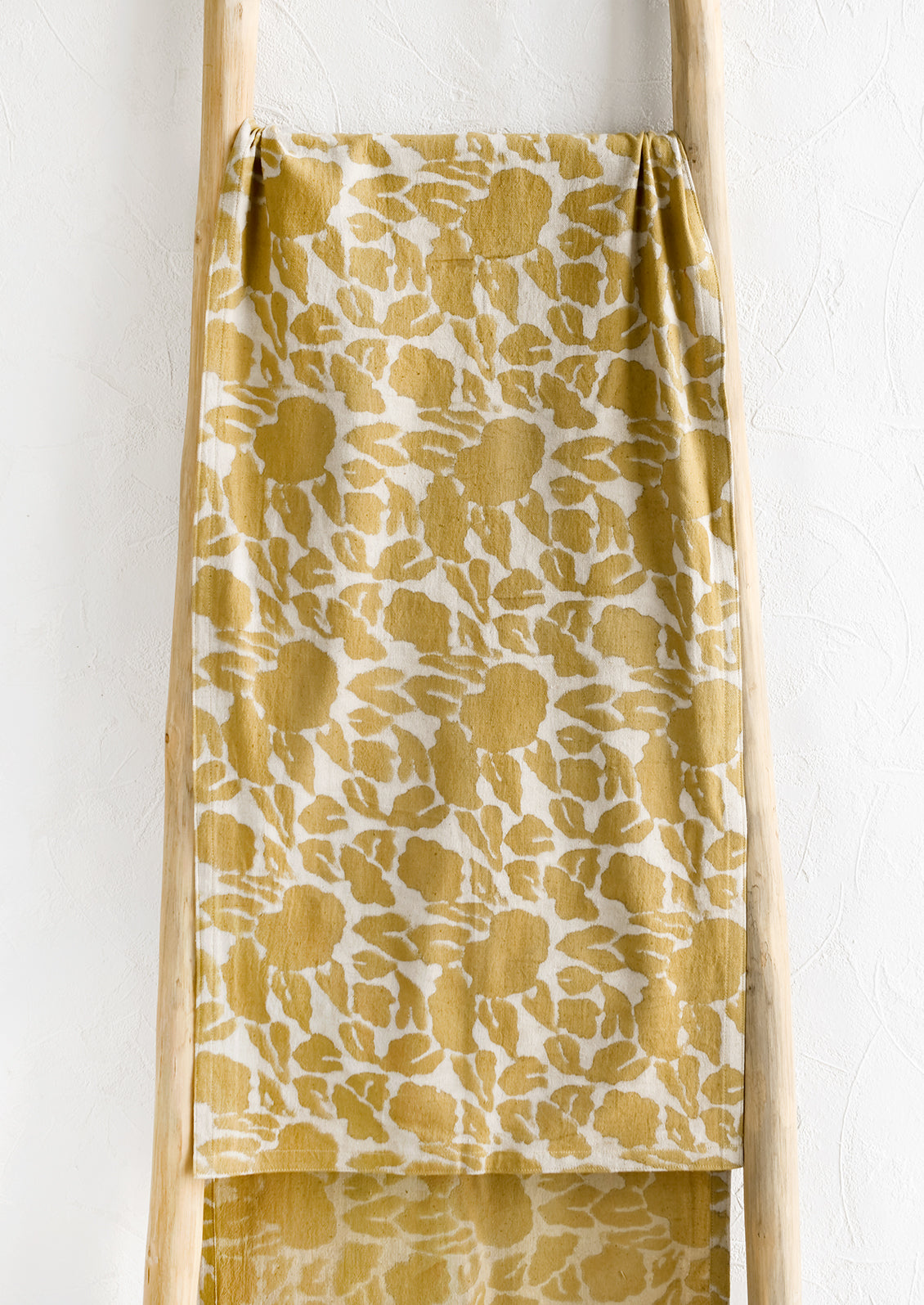 A mustard floral print table runner.