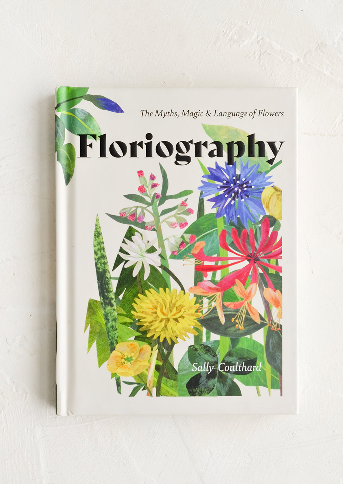 A book titled "Floriography" with botanical print cover.