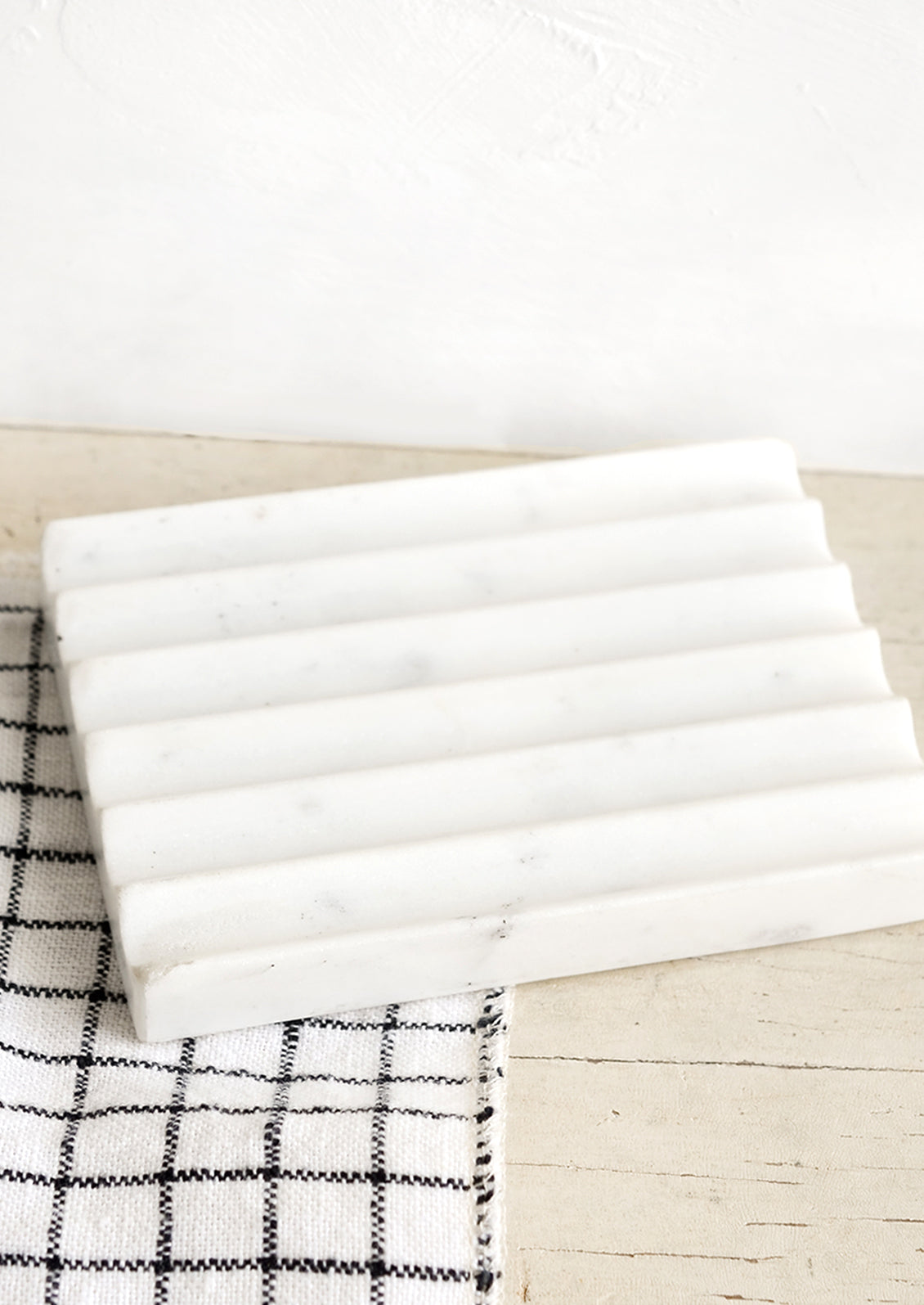 A fluted soap dish made from solid marble.