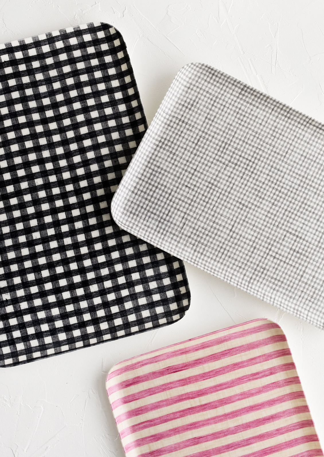 Patterned linen trays in assorted sizes and colors.