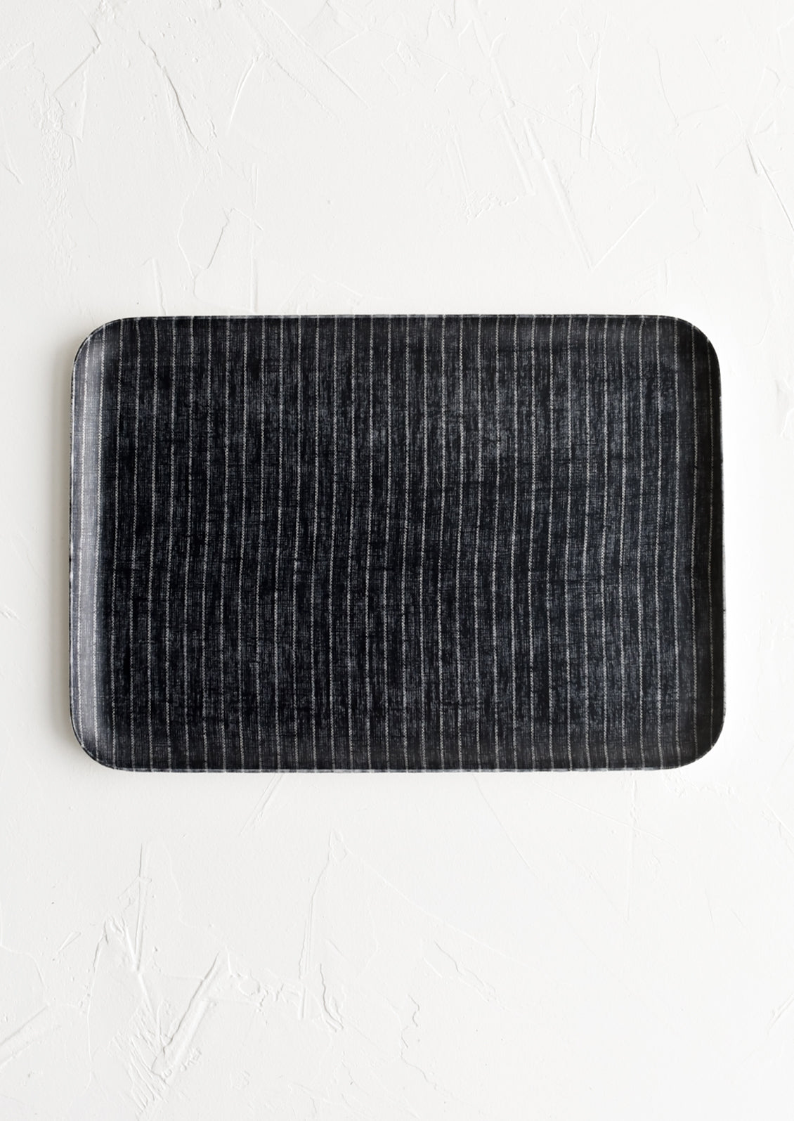 A small tray in charcoal pinstripe print.