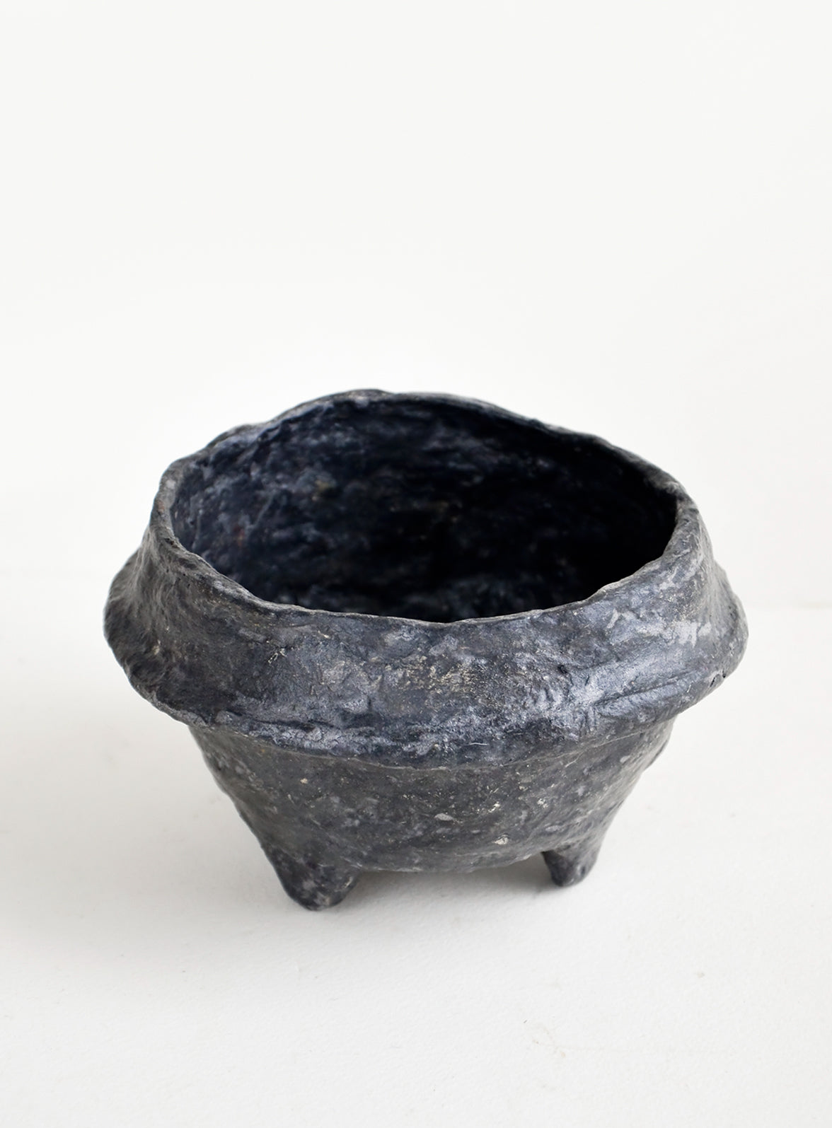 Small, decorative paper mache bowl in footed silhouette and black in color