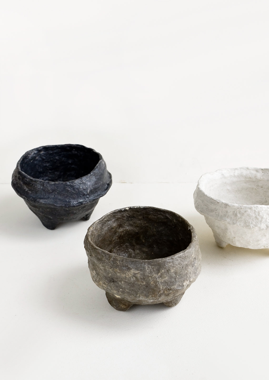 Small, decorative footed bowls made from paper mache in either white, black or brown