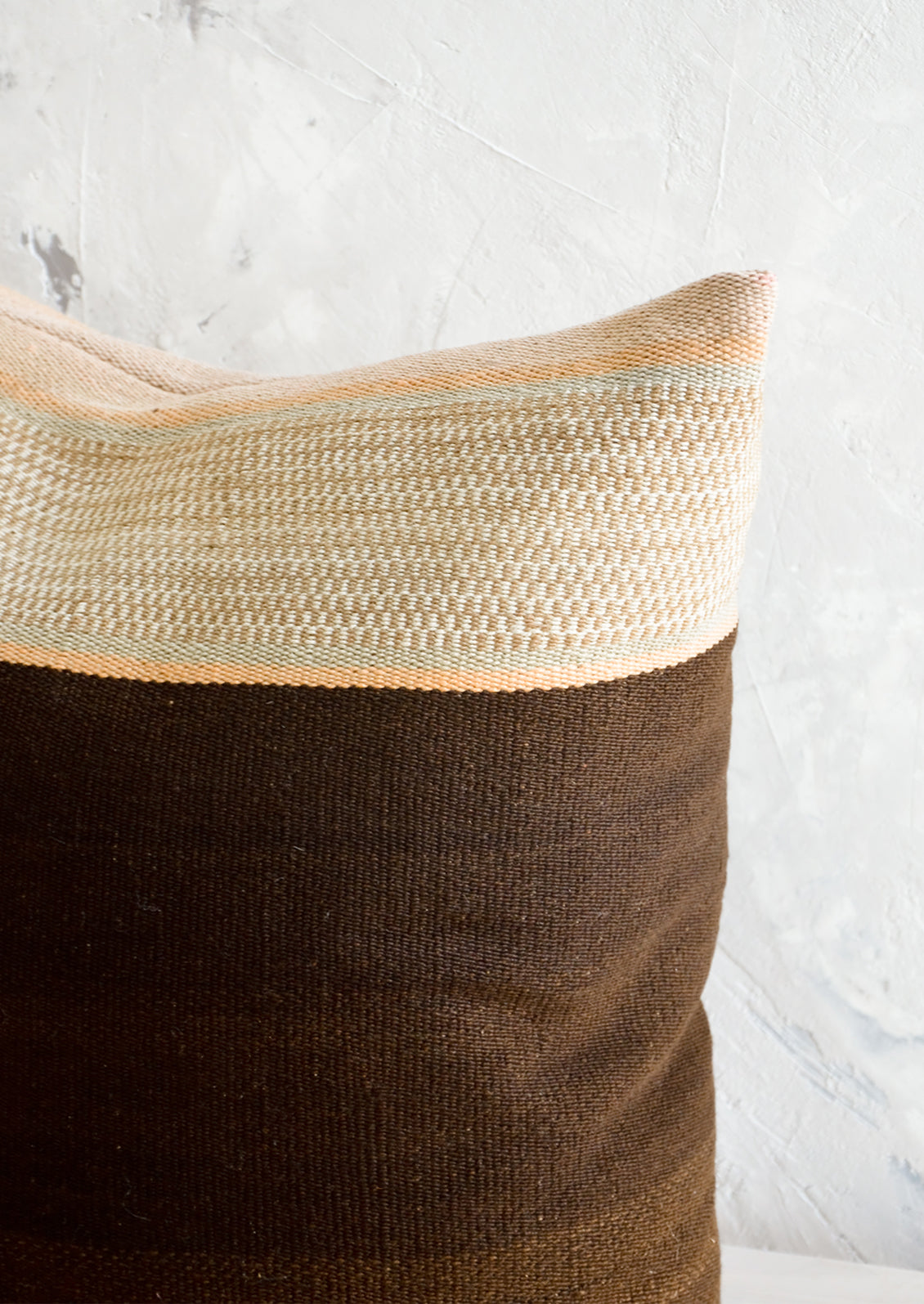 Throw pillow made from vintage wool fabric in brown and beige