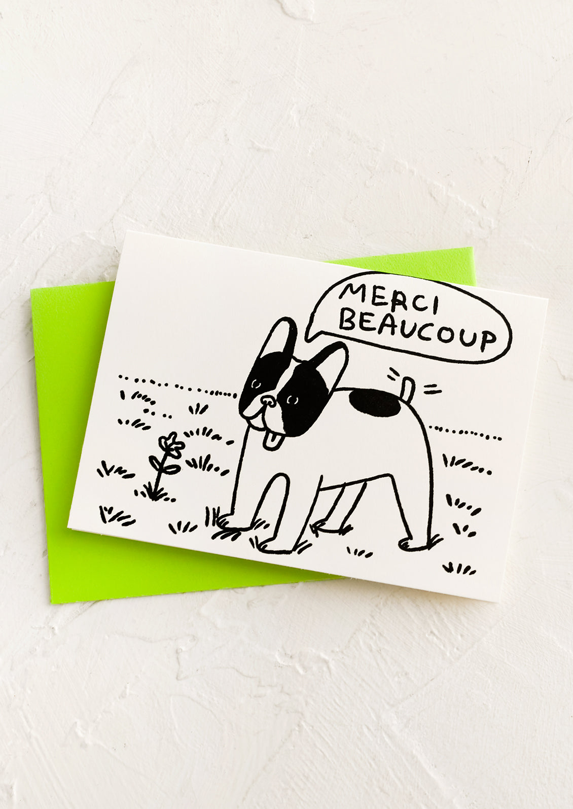 A card with sketch of french bulldog saying "Merci beaucoup".