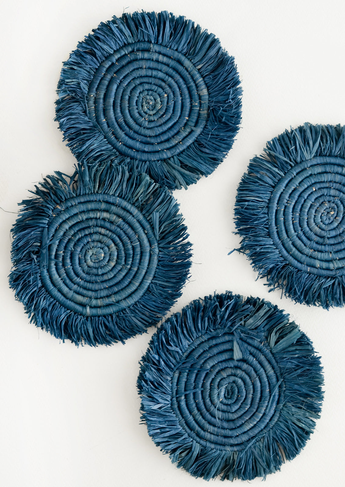 Set of 4 Circular Raffia Coasters with Fringed Trim in Coastal Blue