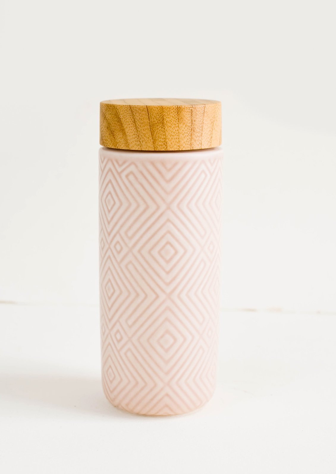 Geometric textured ceramic tall travel tumbler in light pink with bamboo lid