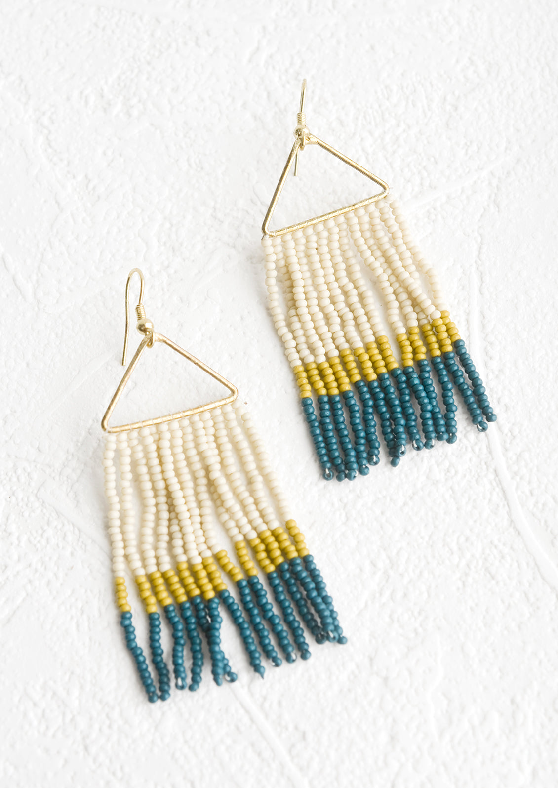 Beaded earrings with triangular metal frame and fringed beads below