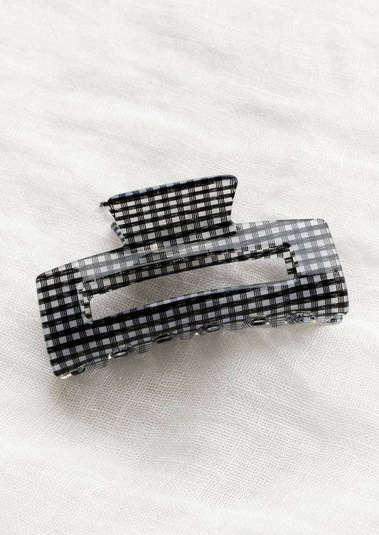 A gingham print hair claw in black.