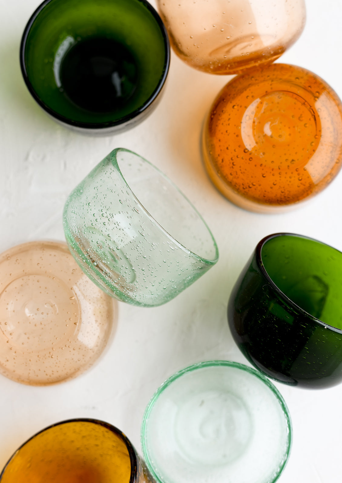 Small tinted glass bowls in assorted colors.