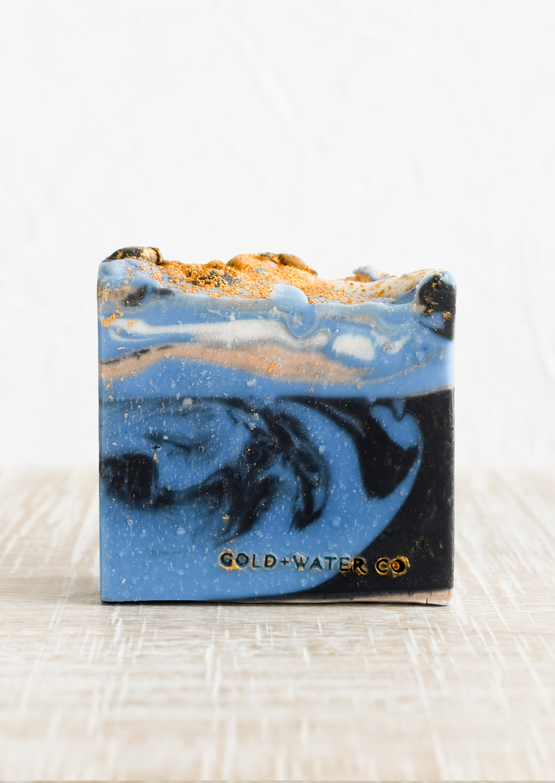 A bar of soap in blue, gold and black.