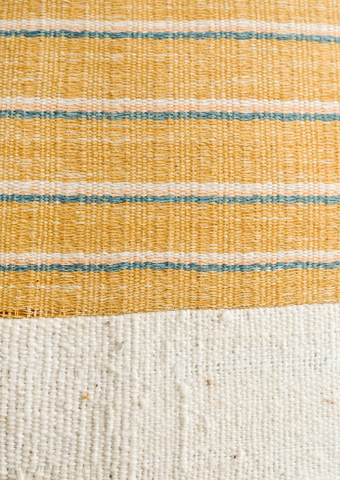 A mustard, ivory, peach and turquoise striped fabric combined with natural mudcloth fabric.