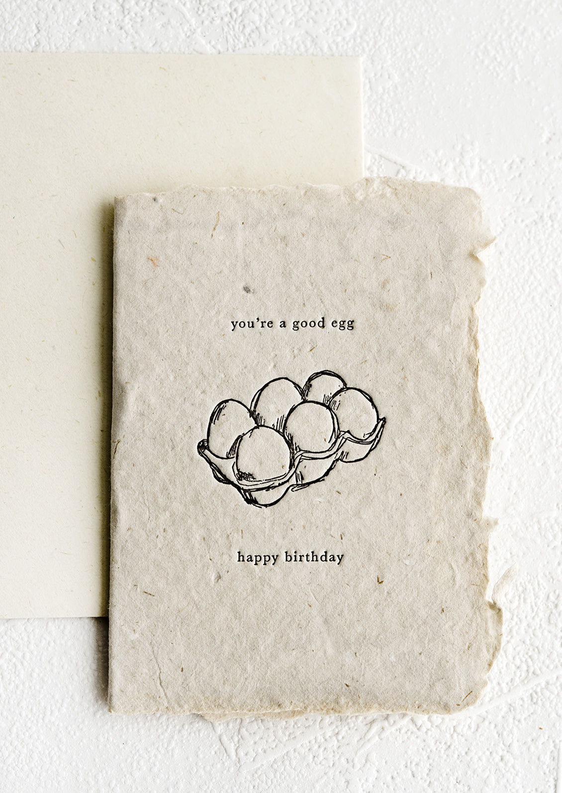 A birthday card made from handmade paper with image of an egg carton.